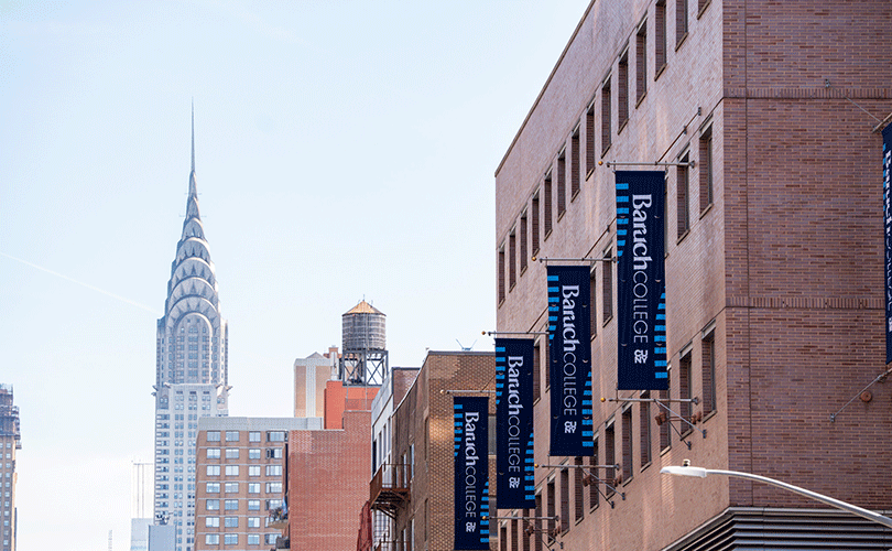 Baruch College campus banners line a New York City street with the Chrysler Building in background.